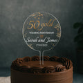 a 50th wedding anniversary cake with a cake topper