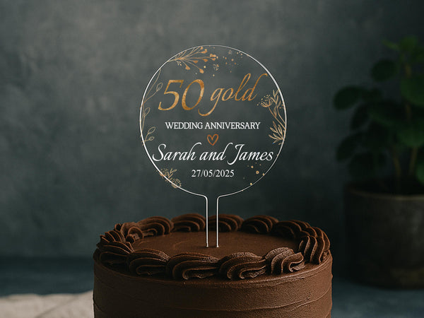 a 50th wedding anniversary cake with a cake topper