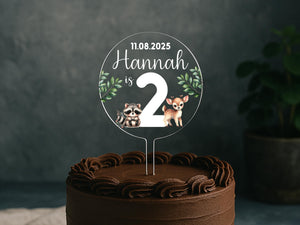 a cake with a couple of raccoons on top of it