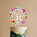 Personalised celebration cake topper featuring geometric frame with pink peonies, orange poppies, blue wildflowers and custom name Sophie 30 on elegant green and gold celebration cake
