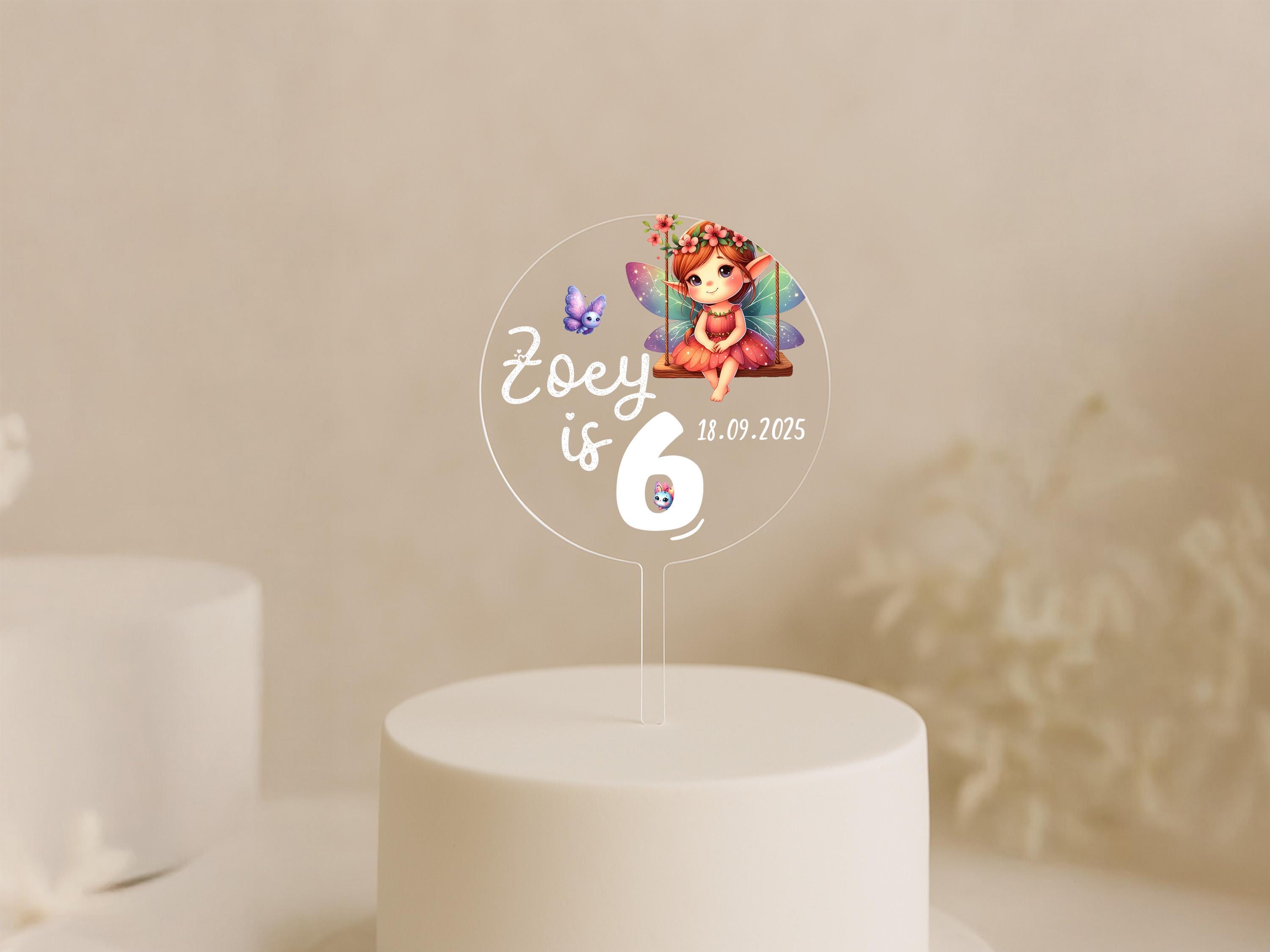 a cake with a picture of a fairy on top of it