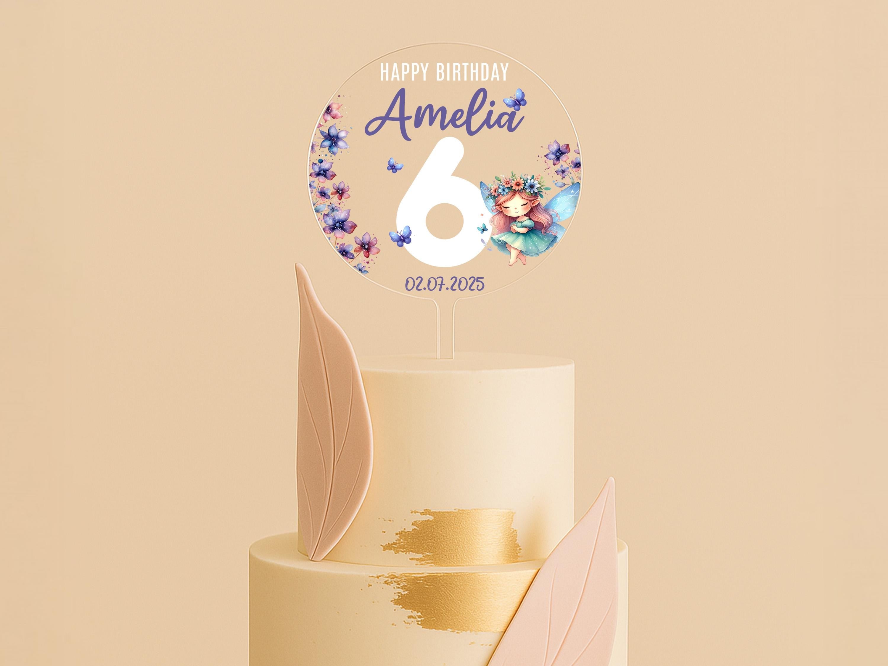 a white and pink cake with a happy birthday sign on top