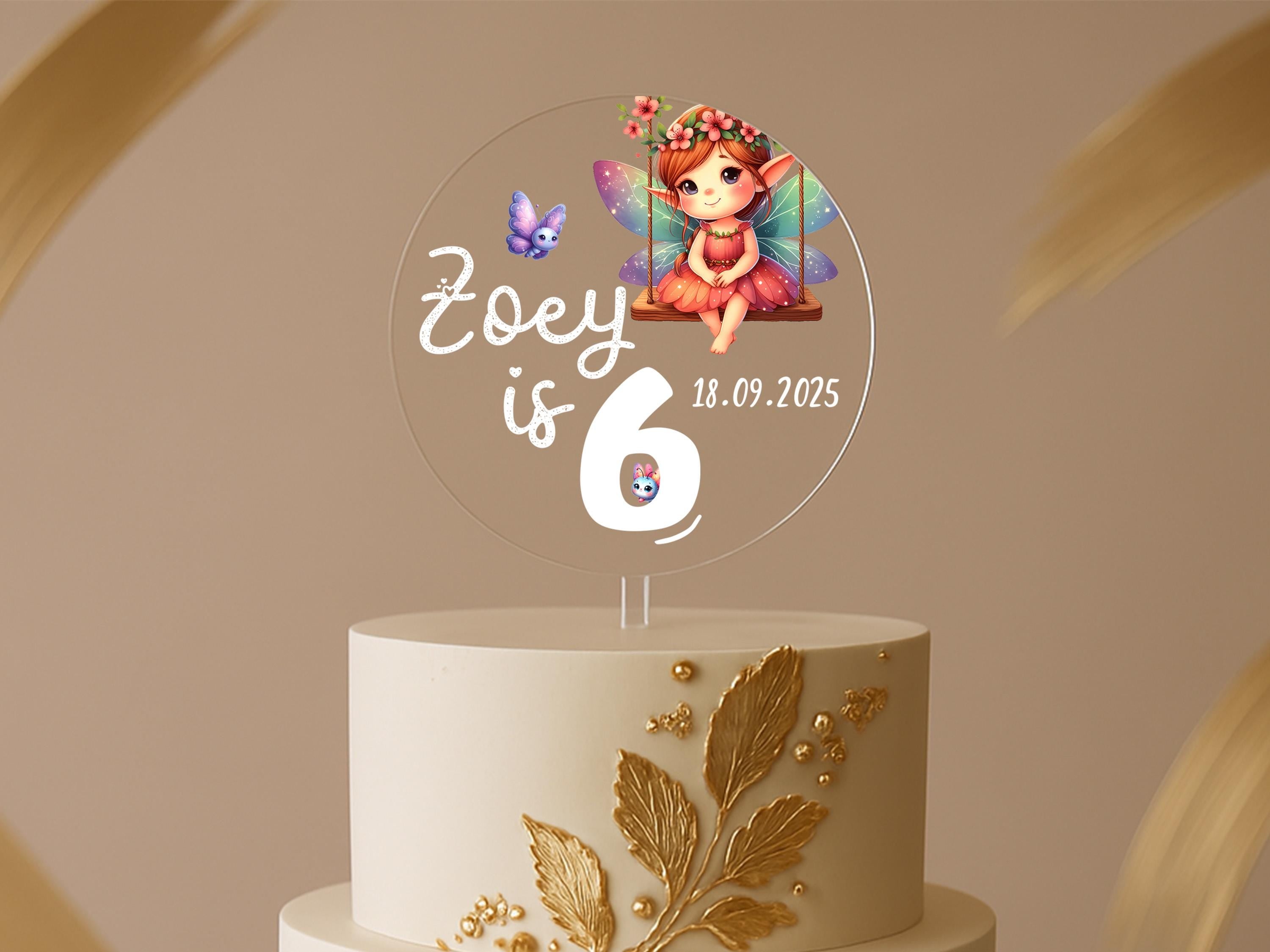 a birthday cake with a picture of a fairy on top
