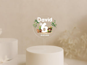 a white cake with a cake topper that says david is 6