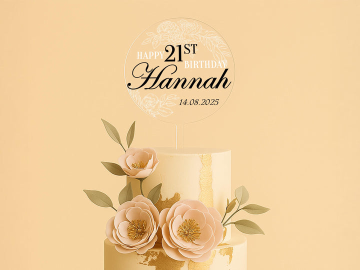 a three tiered cake with flowers and a happy 21st birthday sign