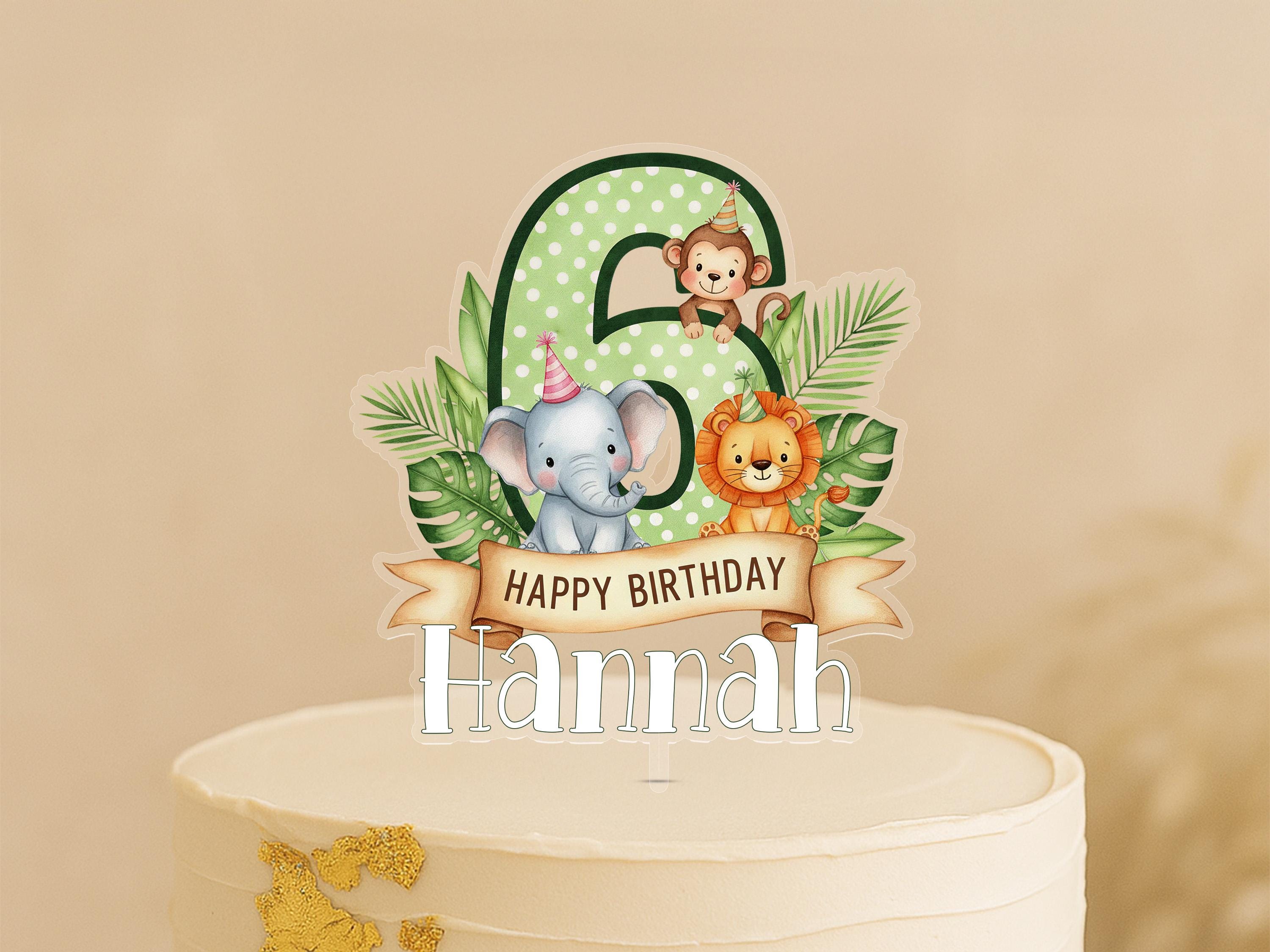 A birthday cake topper with a number 6, featuring a monkey, elephant, and lion surrounded by tropical leaves.
