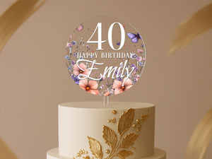 a birthday cake with flowers and butterflies on it