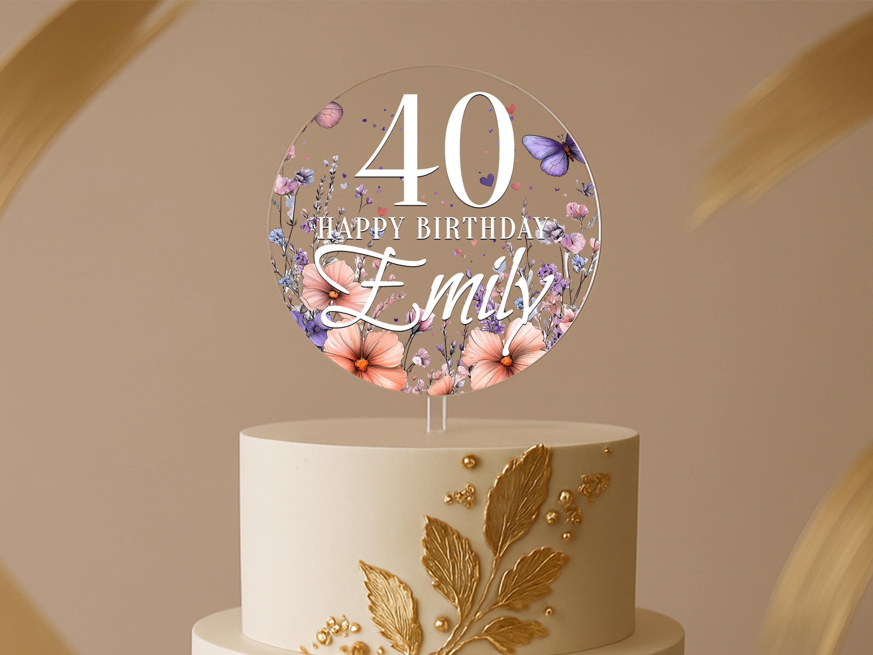 a birthday cake with flowers and butterflies on it