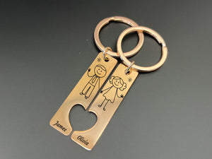 Matching couple keychain set with hand-drawn stick man and woman, personalized names, heart cutout, unique wedding present