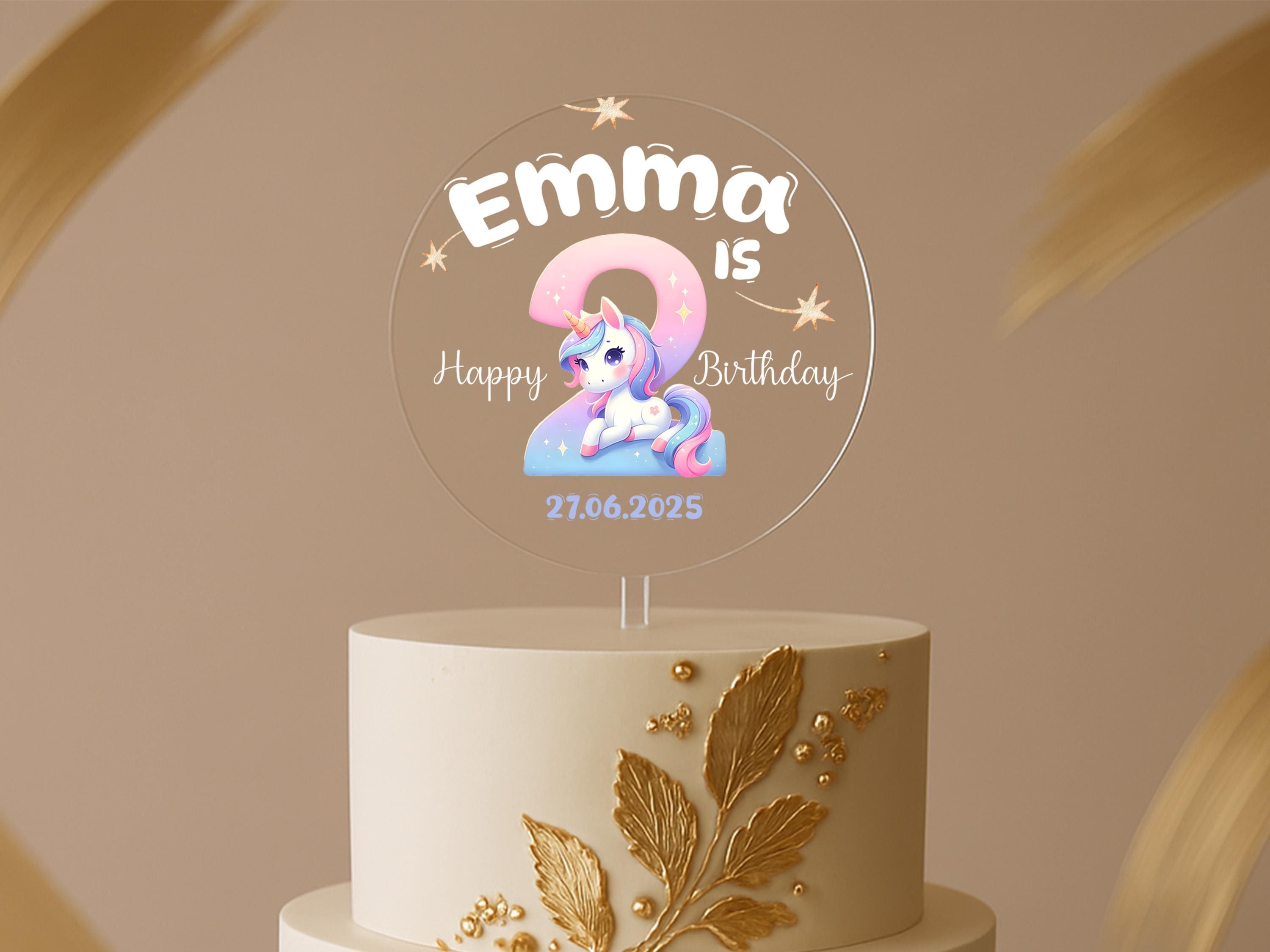 a birthday cake with a unicorn on top of it