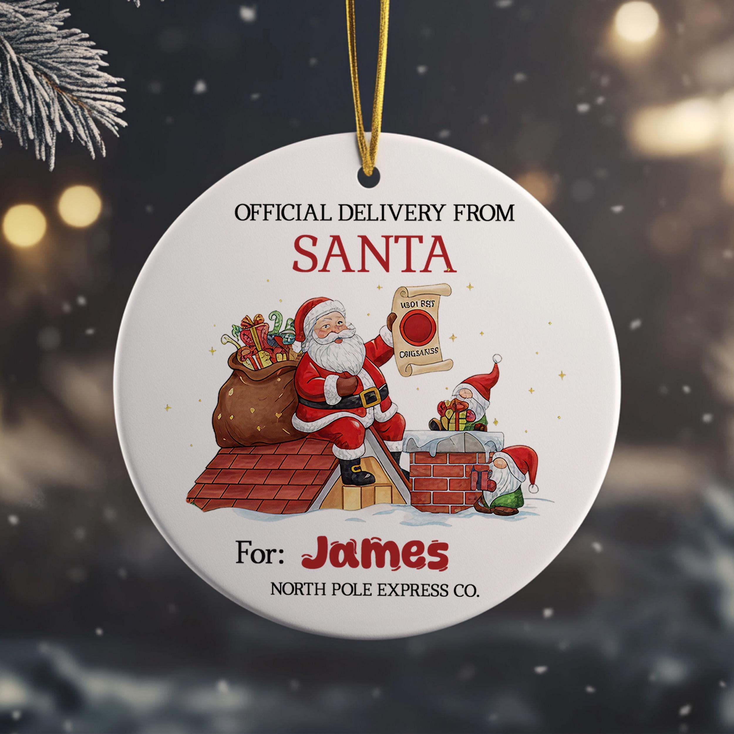 a round ornament with a Santa Claus figure sitting on a rooftop, holding a bag of presents. The ornament is labeled as an "Official Delivery from Santa" and is intended for a person named James.