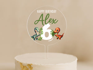 a birthday cake with a dinosaur topper on it