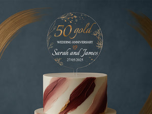 a white and red wedding cake with a sign on top