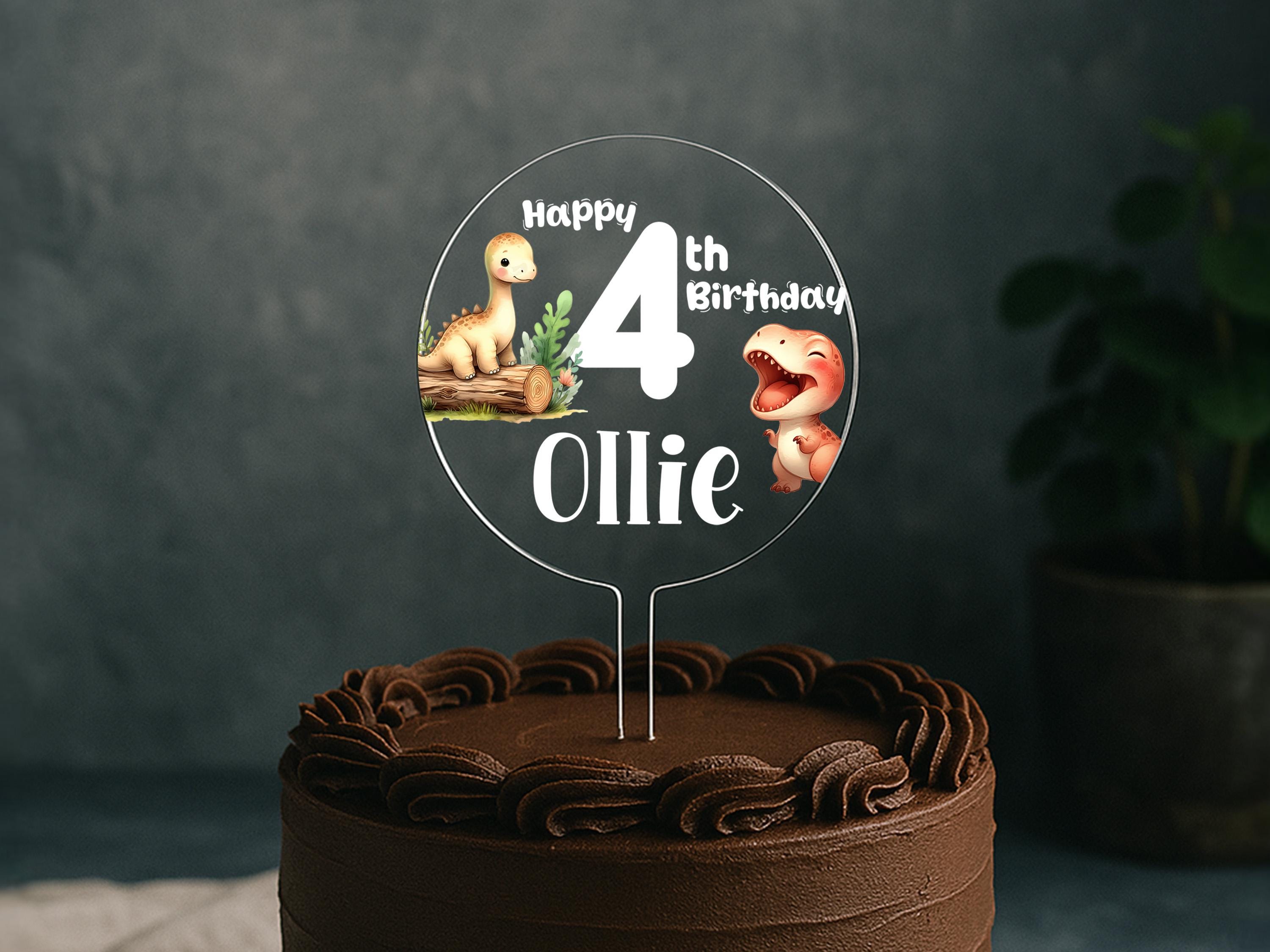 a birthday cake with a dinosaur cake topper