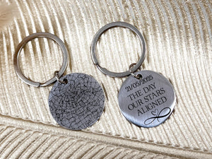 Silver star map keychain with engraved night sky