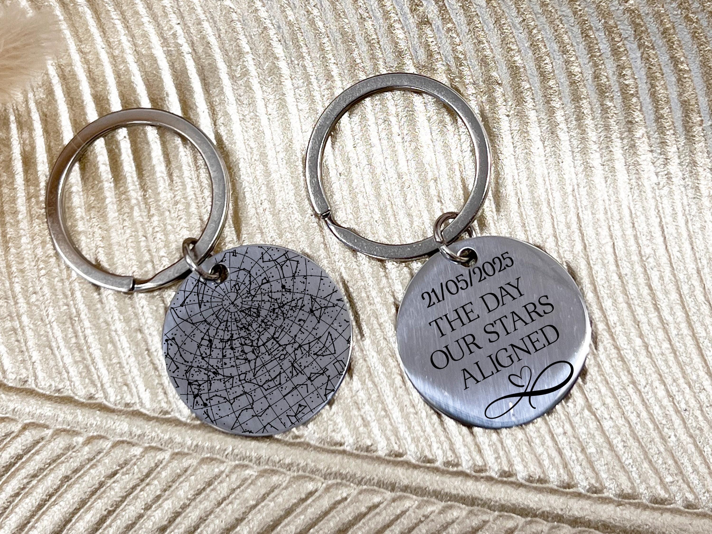 Silver star map keychain with engraved night sky