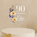 a birthday cake with a white frosting and flowers on it