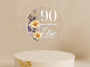 a birthday cake with a white frosting and flowers on it