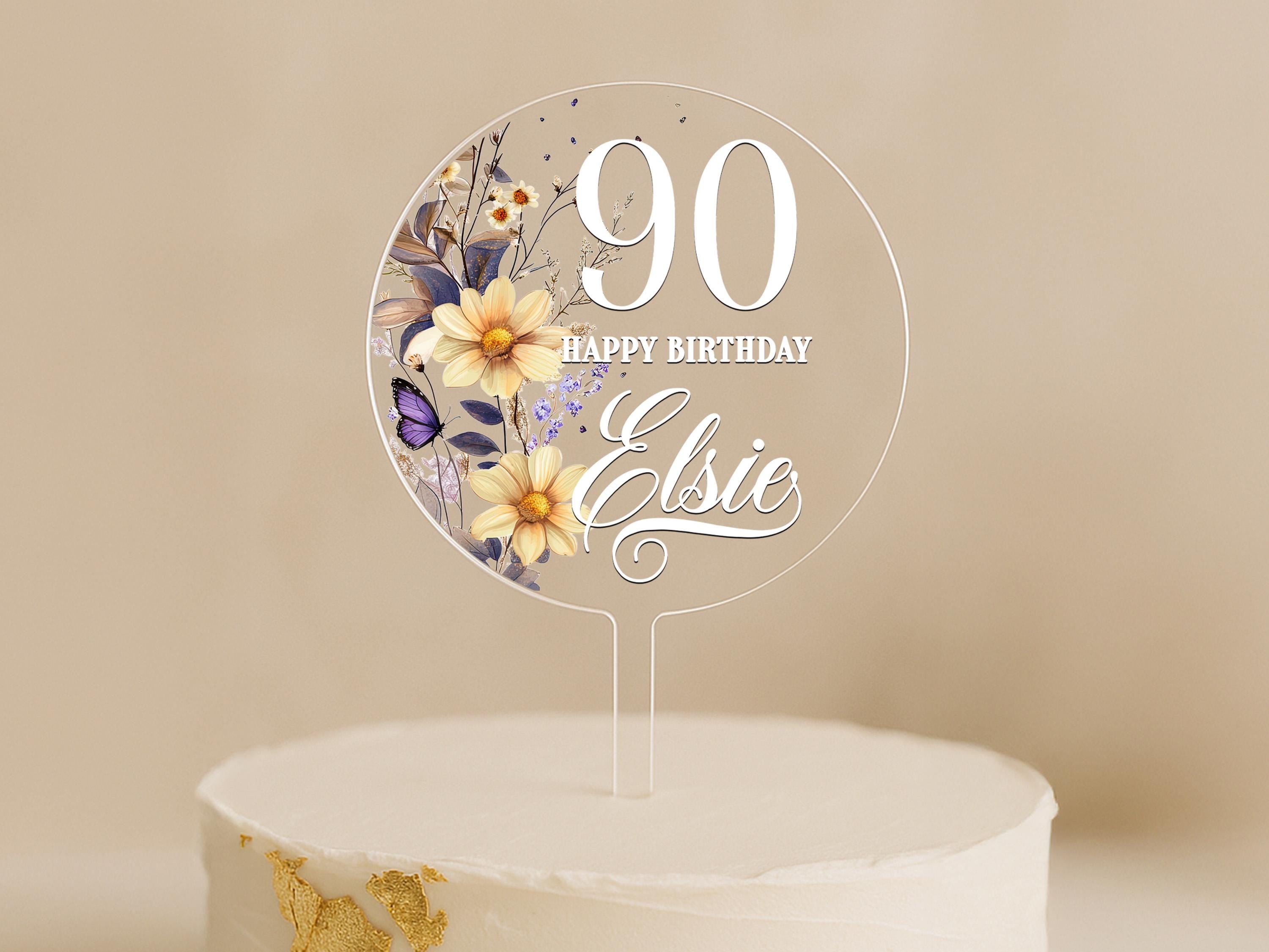 a birthday cake with a white frosting and flowers on it