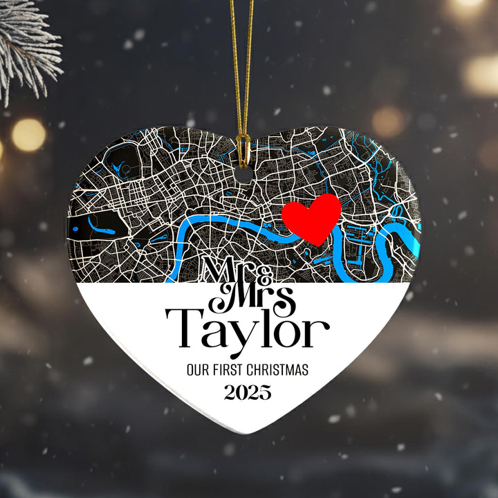 A heart-shaped ornament with a map of London and a red heart symbol, along with the text &quot;Mrs Taylor&quot; and &quot;Our first Christmas&quot; printed on it.