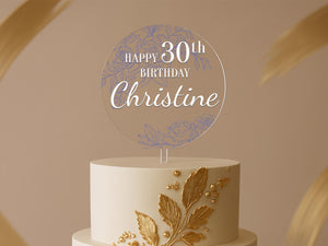 a birthday cake with a white and gold frosting