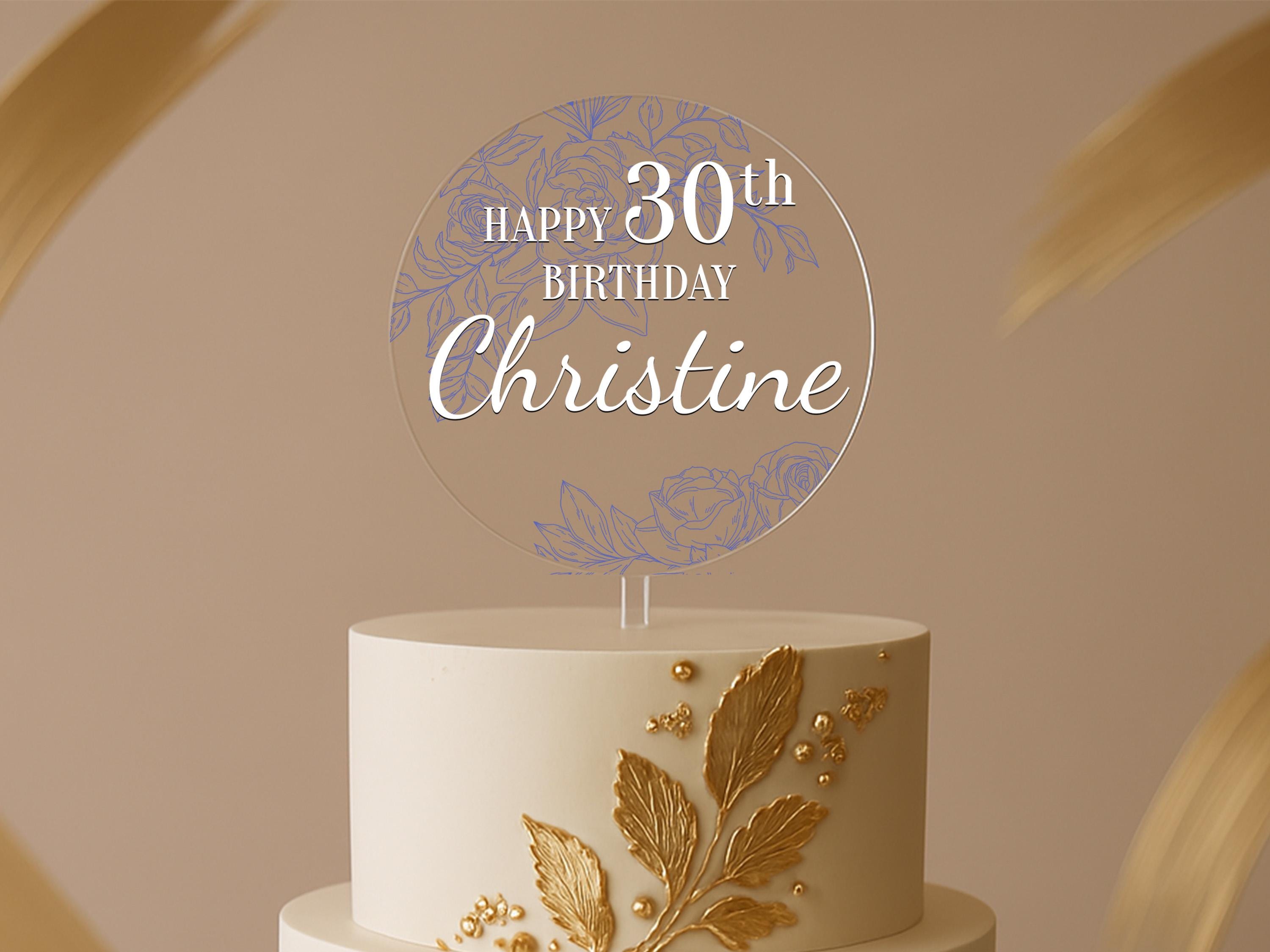 a birthday cake with a white and gold frosting