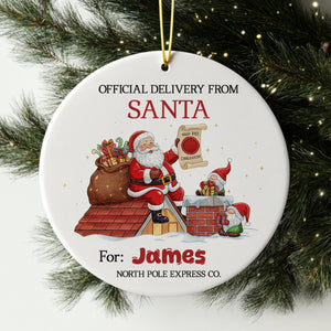 Santa Claus holding a sign that says "I'm sorry, I can't deliver organic produce" and a gnome holding a sign that says "I'm sorry, I can't deliver organic produce". The ornament is hanging from a string, and it is for the person named James.