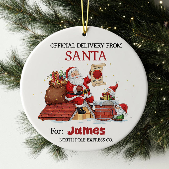 Santa Claus holding a sign that says &quot;I&#39;m sorry, I can&#39;t deliver organic produce&quot; and a gnome holding a sign that says &quot;I&#39;m sorry, I can&#39;t deliver organic produce&quot;. The ornament is hanging from a string, and it is for the person named James.