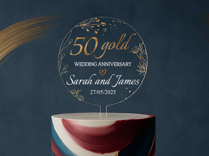 a 50th wedding anniversary cake topper on top of a multi - colored cake