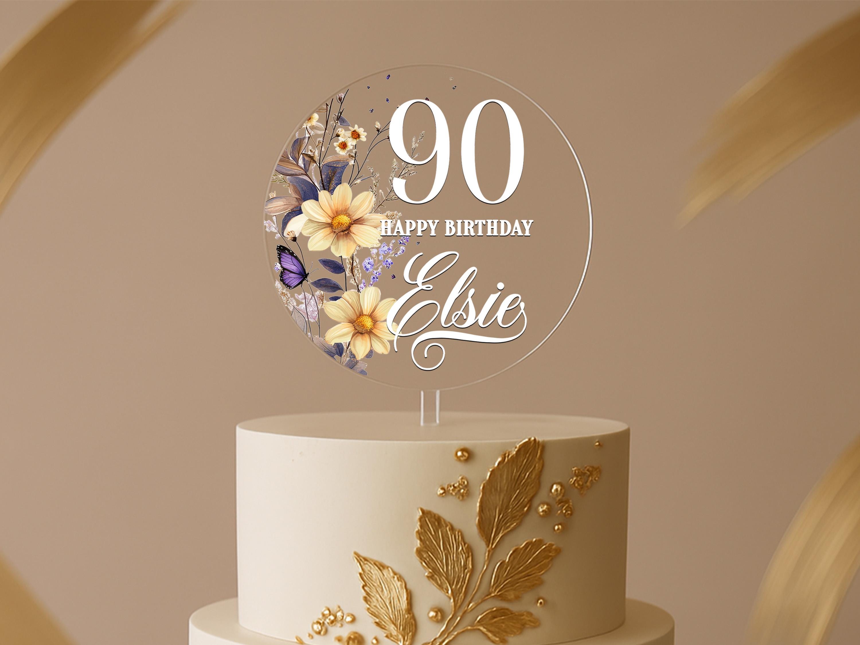 a birthday cake with a floral design on top