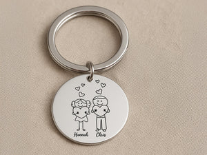 a picture of a couple holding hands on a keychain