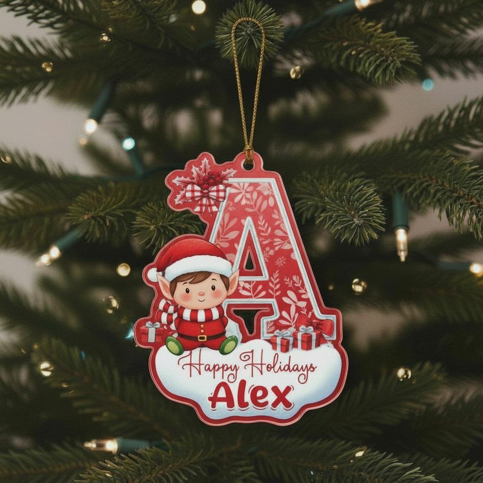A red ornament with a cartoon elf and the name "Alex" is hanging on a Christmas tree.