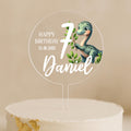 a birthday cake with a dinosaur cake topper