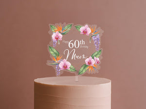 A cake topper with a floral design and the text "Happy 60th Birthday Mum" on it.
