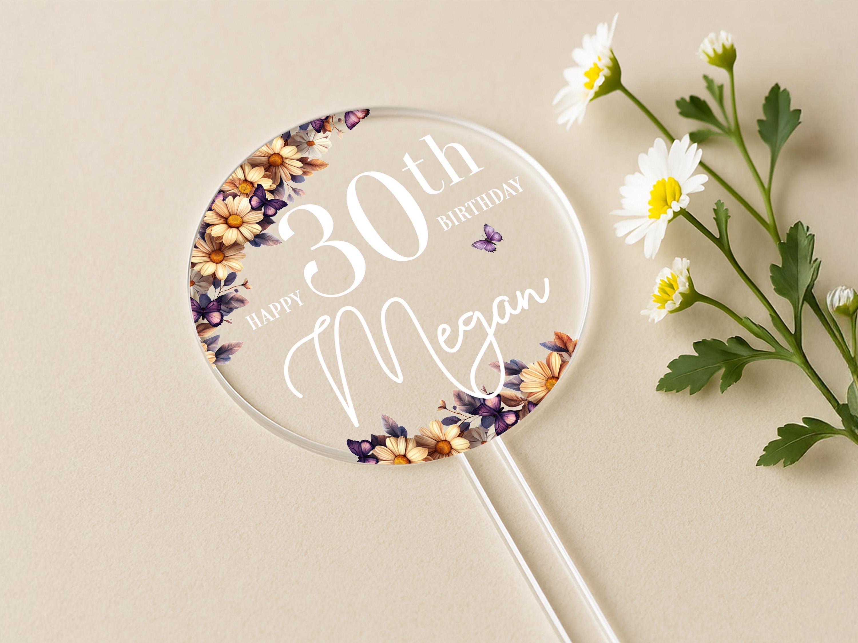 a birthday cake topper with flowers on it