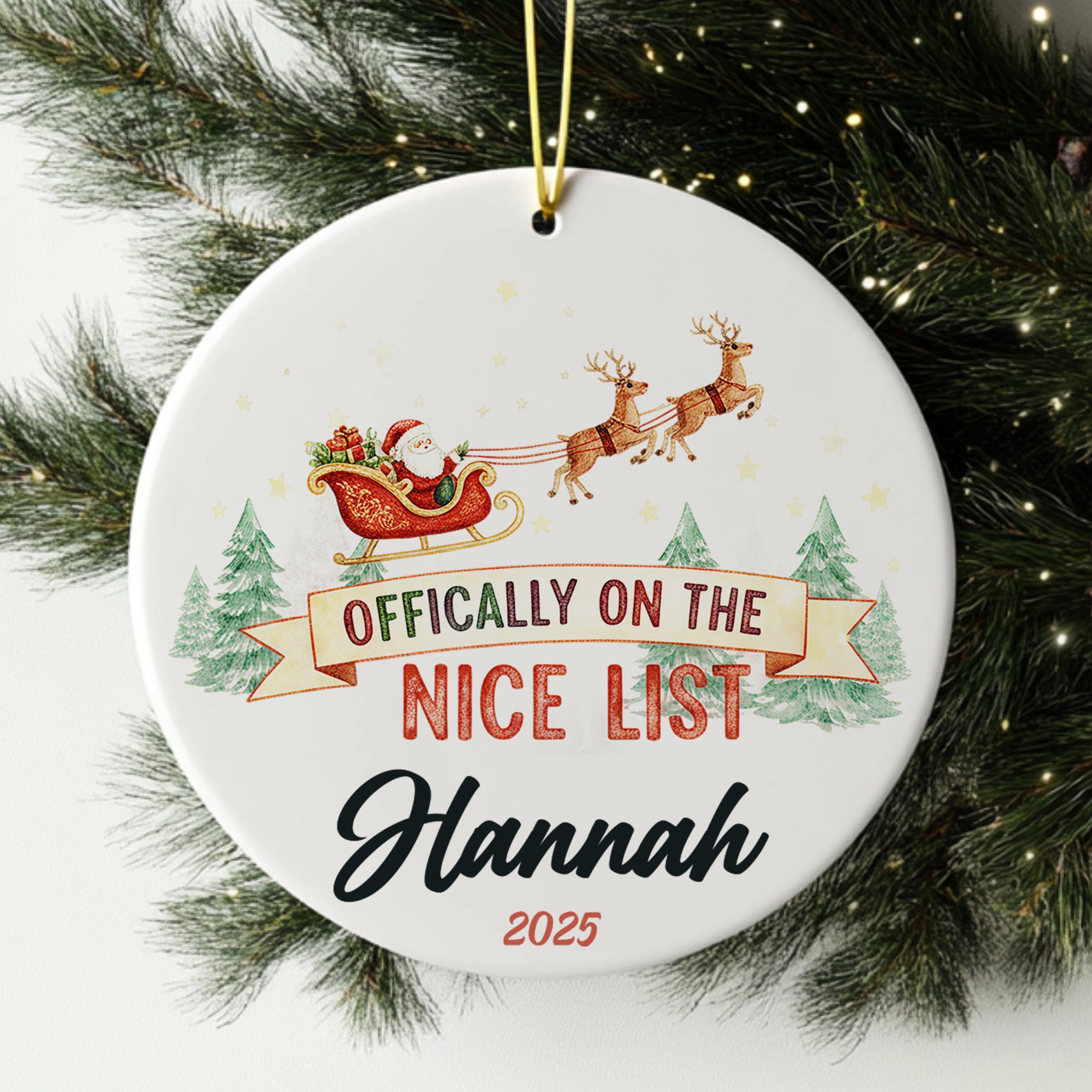 A white ornament with a Santa Claus sleigh and reindeer, along with the text " Officially on the NICE LIST Hannah 2020".