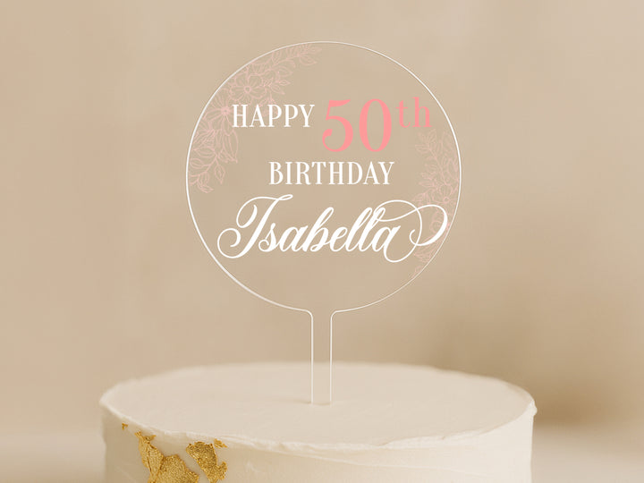 a birthday cake with a white frosting and pink lettering