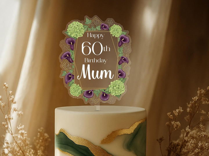 A birthday cake topper with a floral design and the text &quot;Happy 60th Birthday Mum&quot; on it.