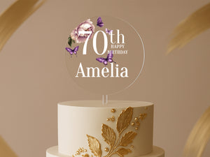 a white and gold cake with a 70th birthday cake topper