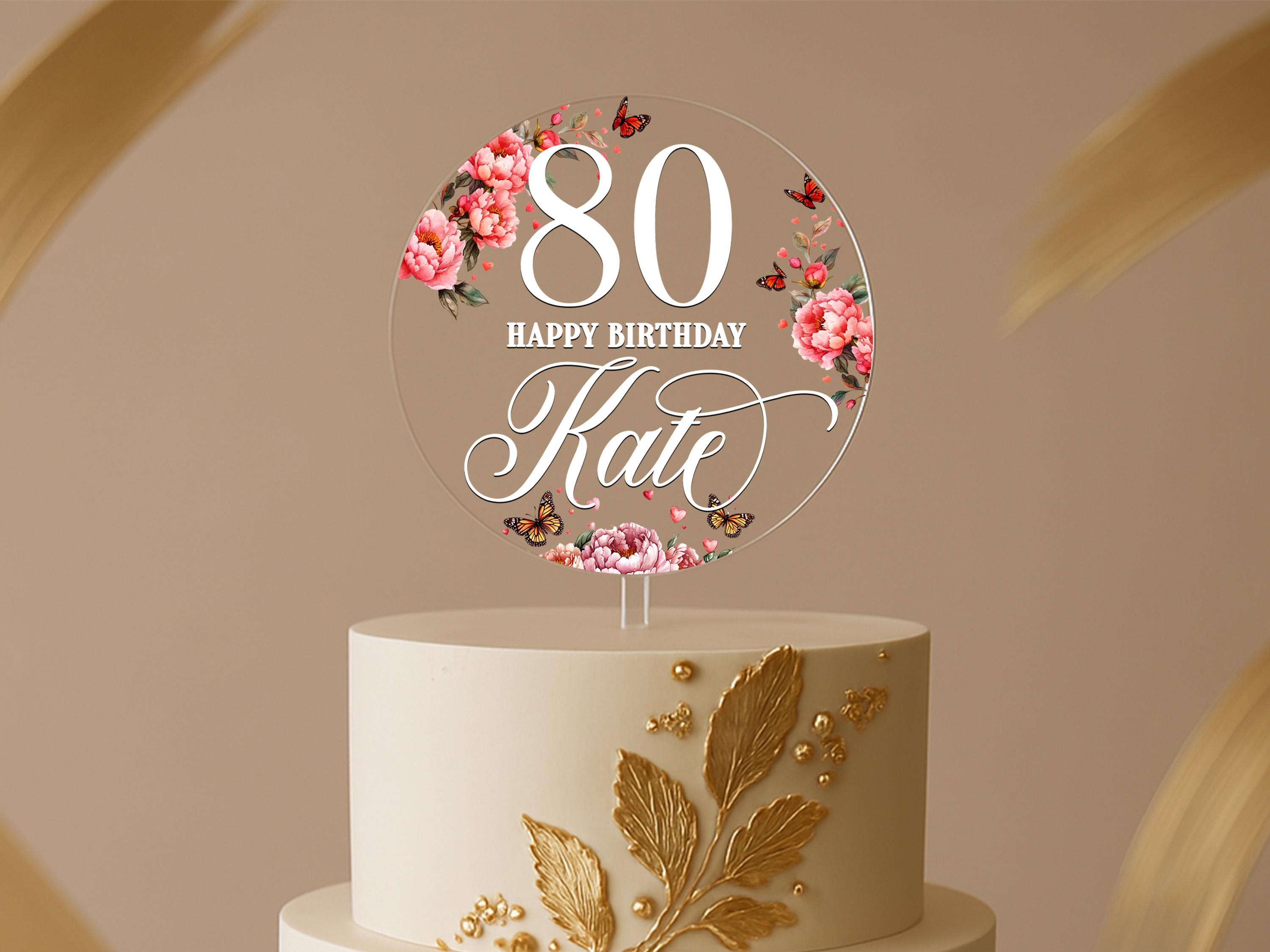 Round 80th birthday cake topper with pink florals, butterflies, and custom name