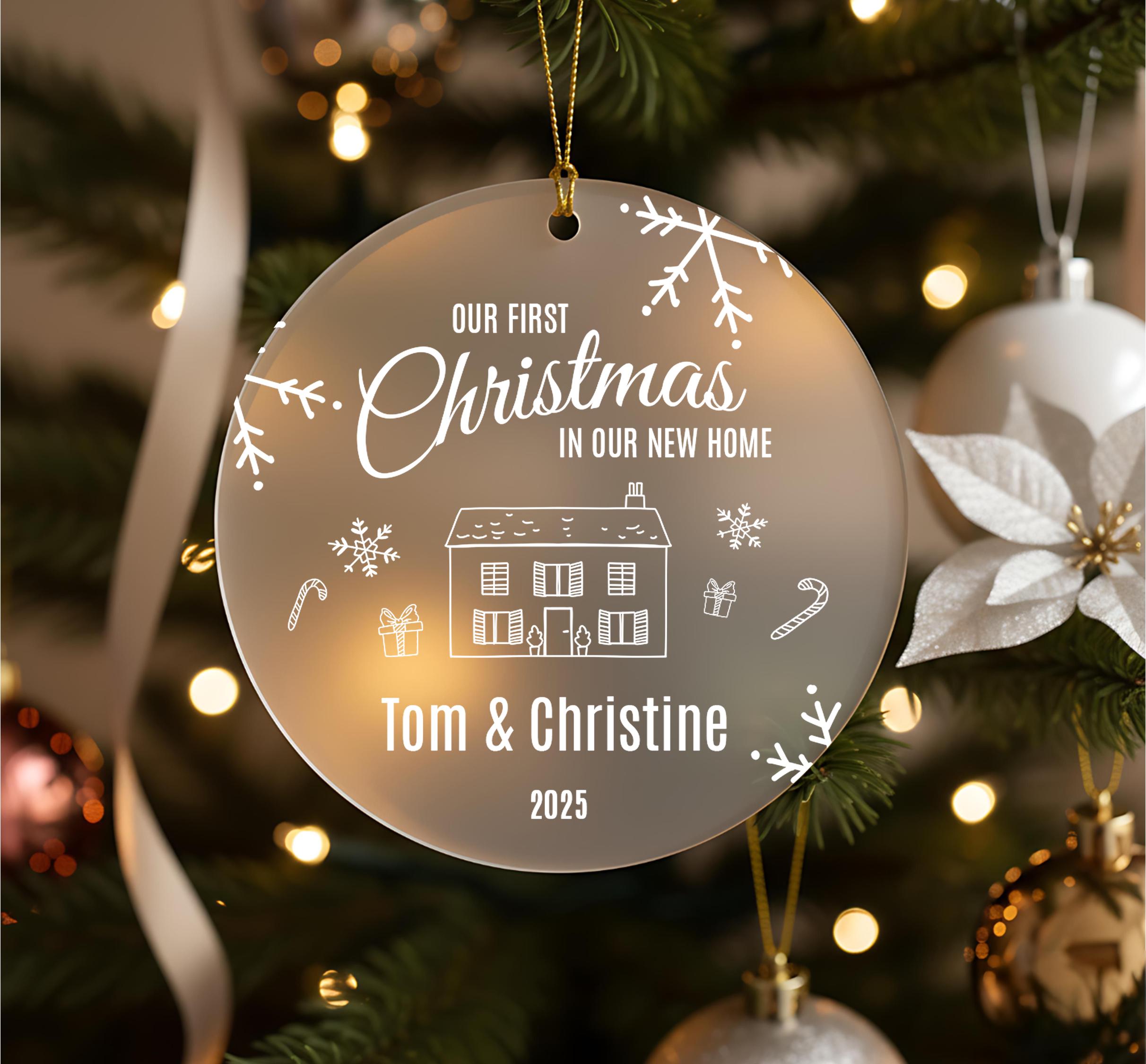A Christmas ornament hanging on a tree, with the text "Our first Christmas in our new home" and the names "Tom & Christine" below it.