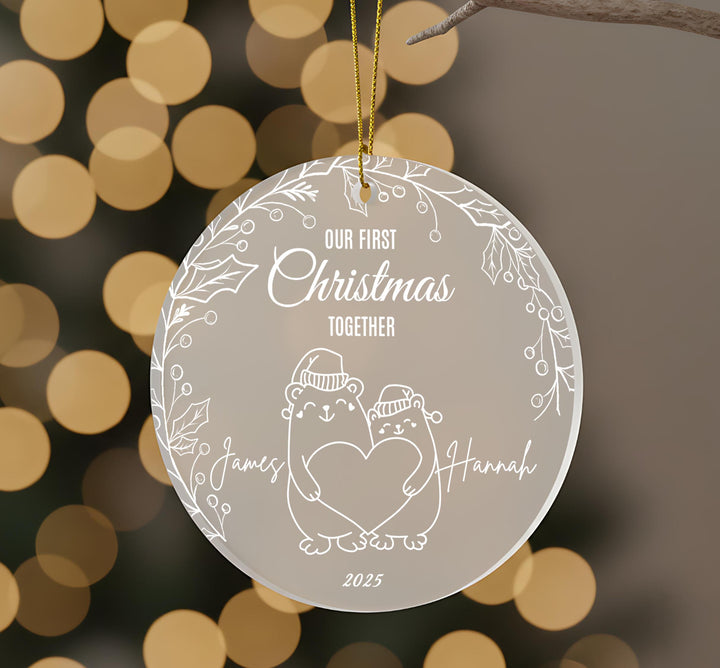 A round ornament with a white background and a couple of bears holding hands, surrounded by a decorative border.