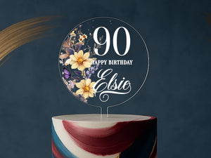a birthday cake with a floral design on top