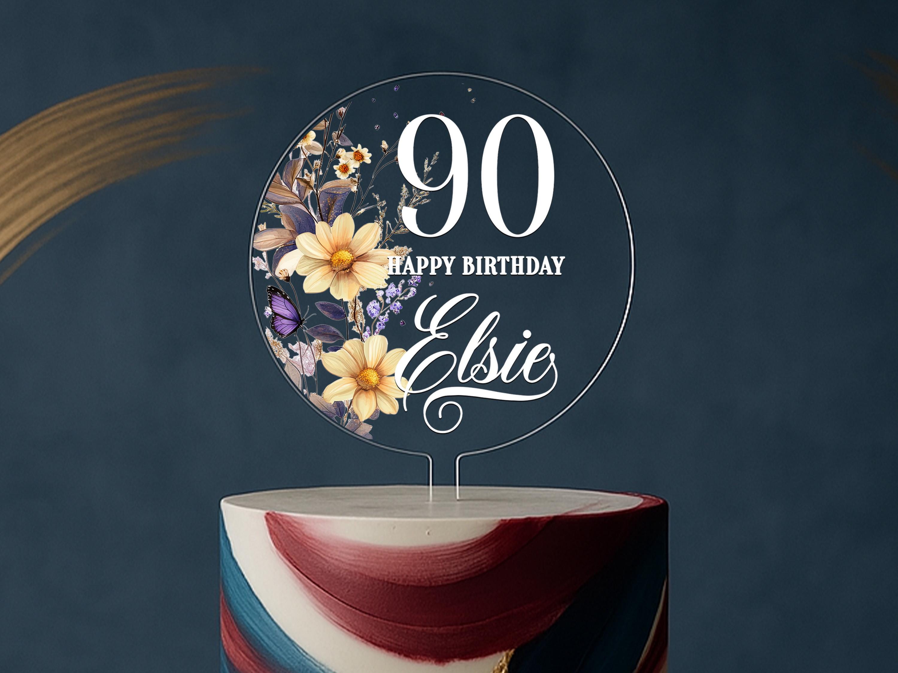 a birthday cake with a floral design on top