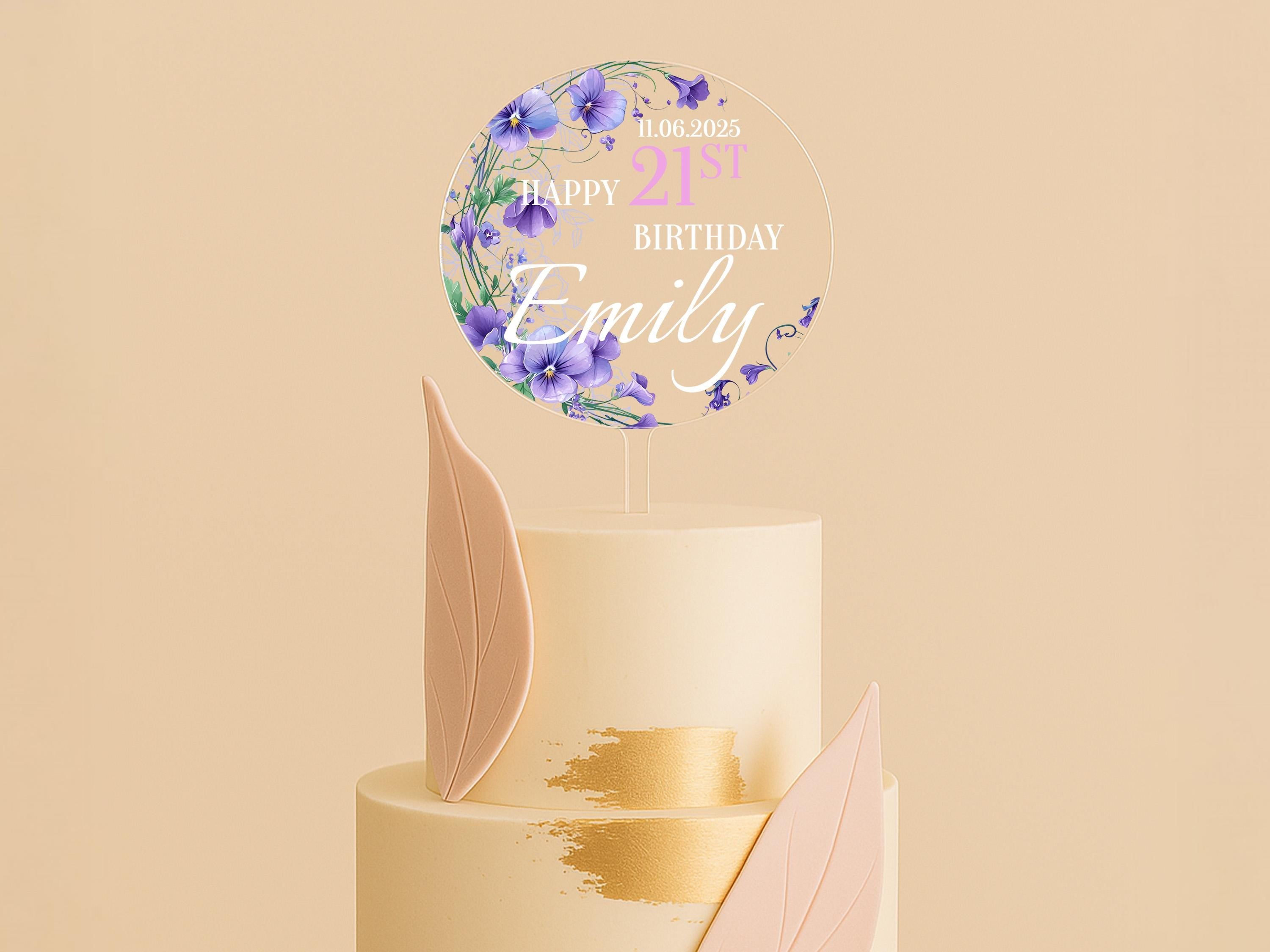 a three tiered cake with a happy birthday sign on top