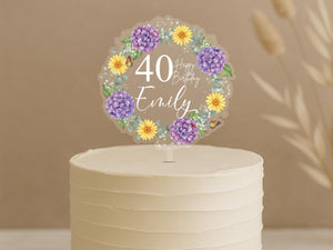 Personalised 40th birthday cake topper featuring elegant circular floral wreath with purple hydrangeas, yellow daisies, butterflies and custom name Emily on white celebration cake