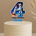 Personalised space birthday cake topper showing number 4 with astronaut, rocket ship, planets and galaxy background, custom name Noah on white cake