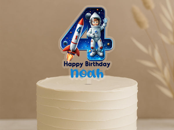 Personalised space birthday cake topper showing number 4 with astronaut, rocket ship, planets and galaxy background, custom name Noah on white cake