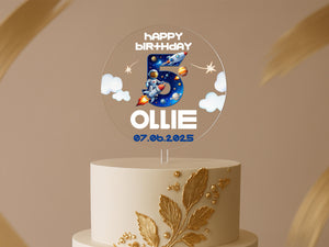 a white and gold birthday cake with the number five on it