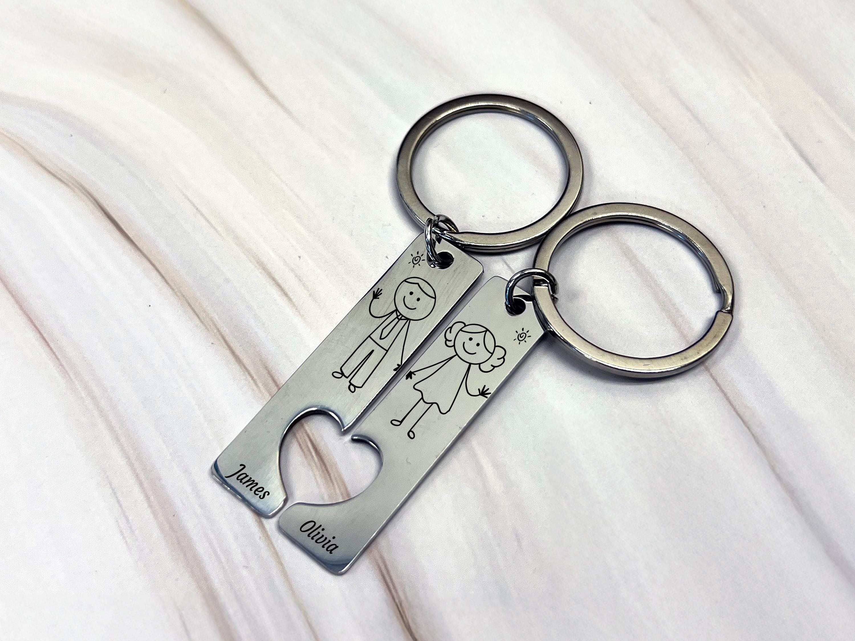 a metal keychain with a picture of a man and a woman on it